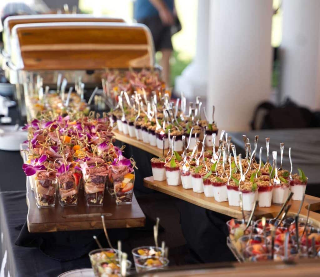 Single serving hors d'oeuvres laid out with a nice presentation including parfaits and charcuterie