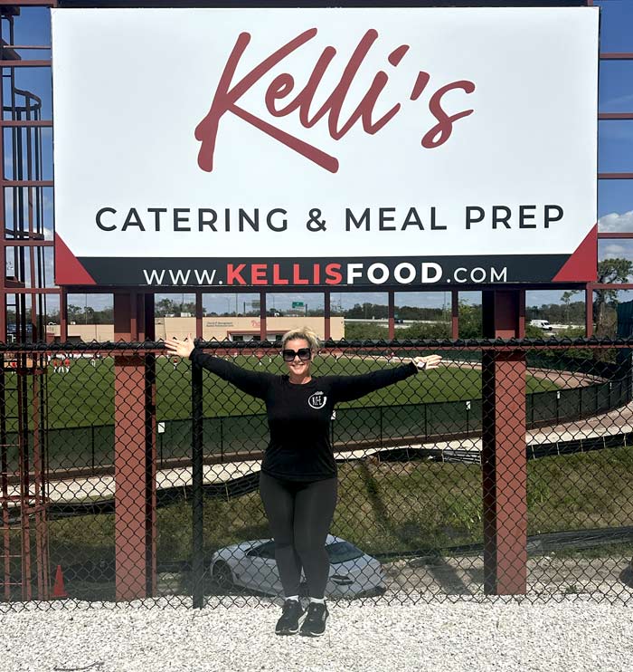 Threshers Stadium Kelli's Sign with Kelli in front of it.